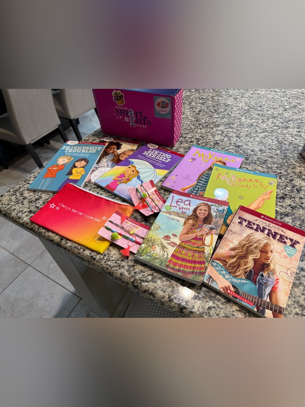 american girl books and gift box with makeup bag and bracelets
